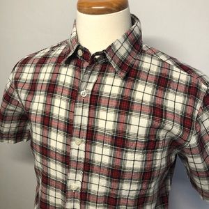 Men's Roots short sleeve shirt. This is a plaid shirt red, white, and black.